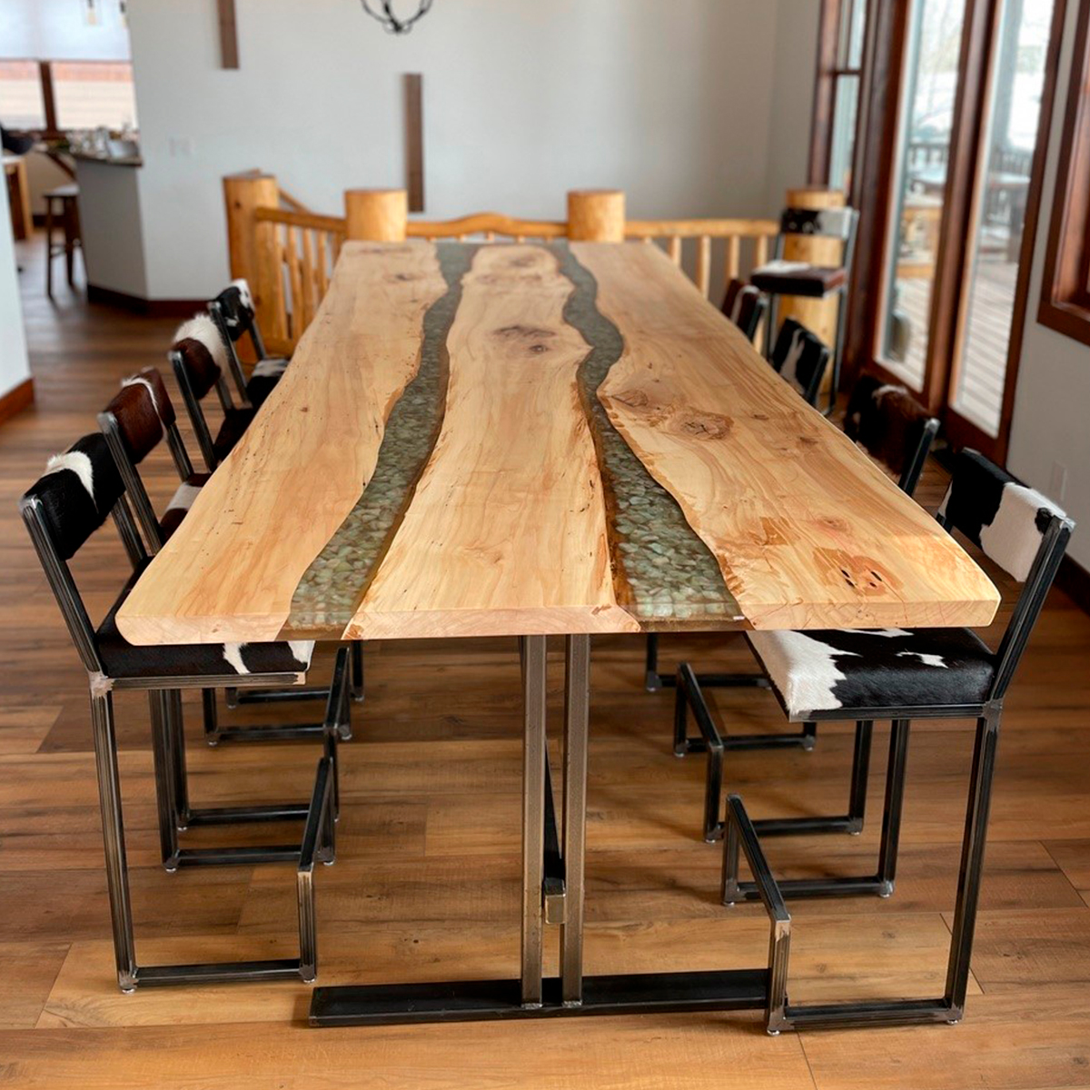 Epoxy Resin River Table in dining room with chairs.